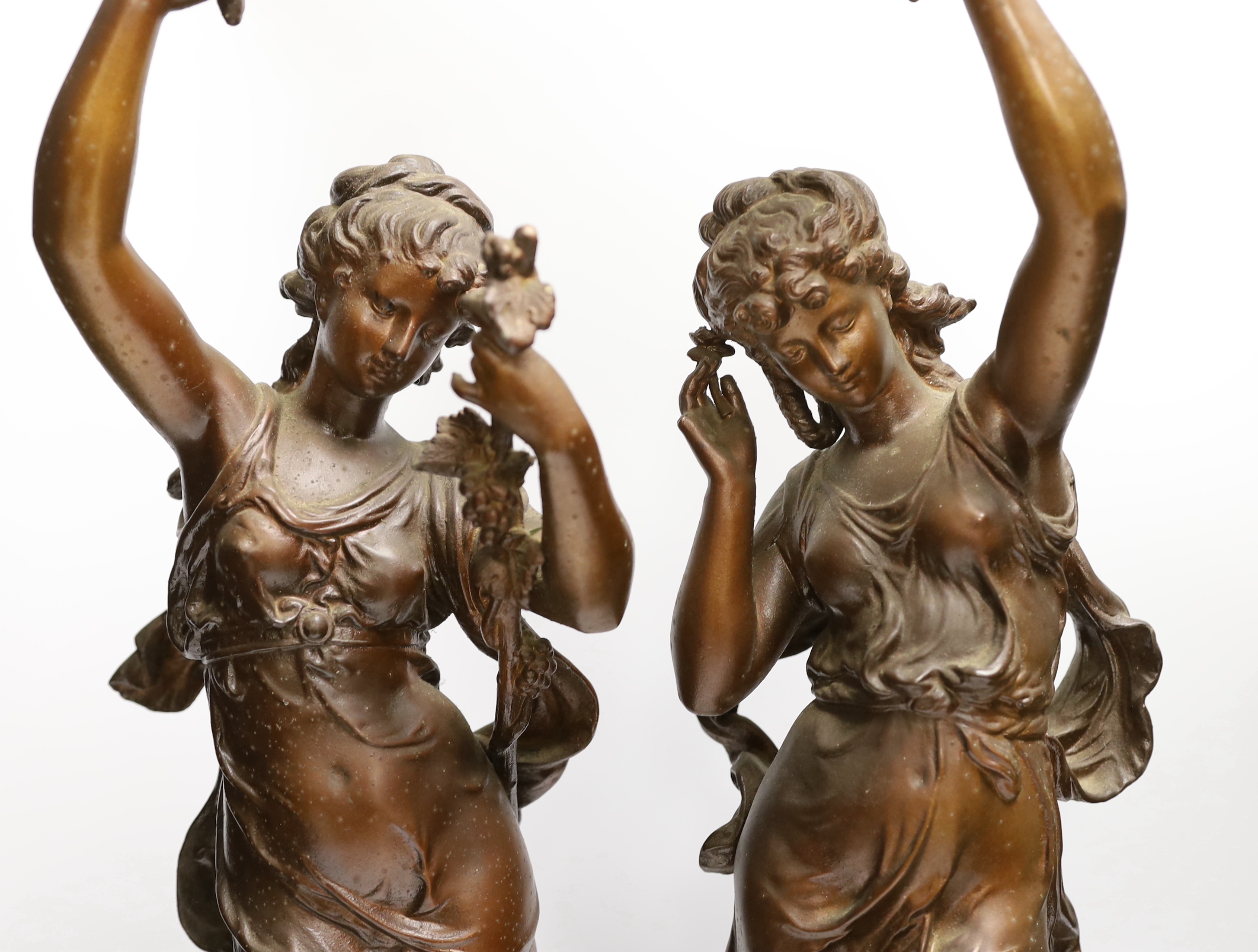 A pair of patinated spelter figural lamp bases, 63cm high not including light fitting